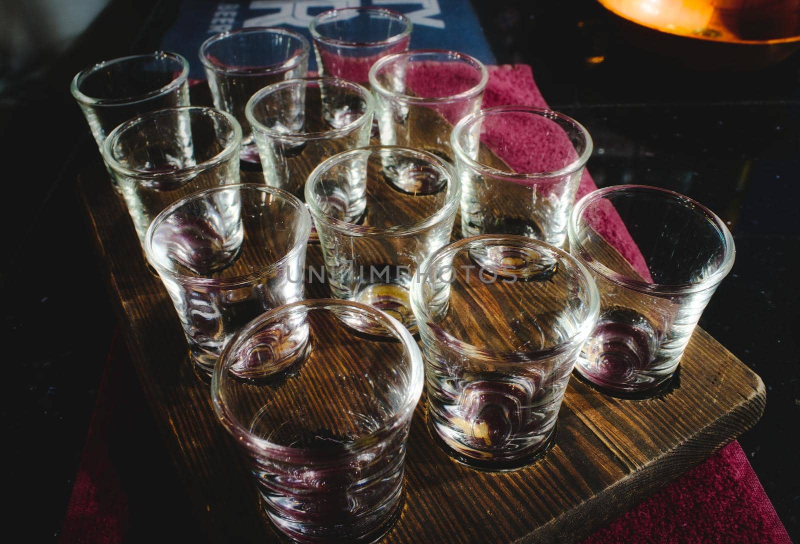 Shot glasses set in a wooden tray in a traditional English pub