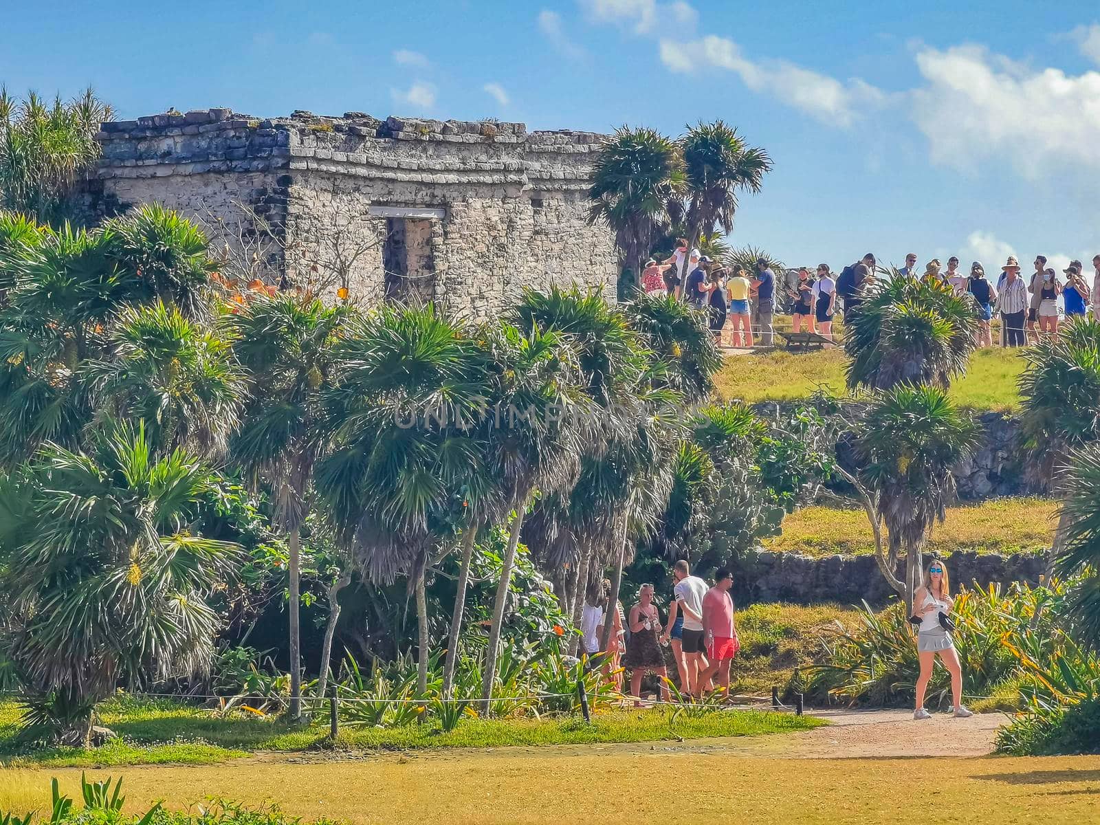 Tulum Mexico 21. February 2022 Ancient Tulum ruins Mayan site with temple ruins pyramids and artifacts in the tropical natural jungle forest palm and seascape panorama view in Tulum Mexico.