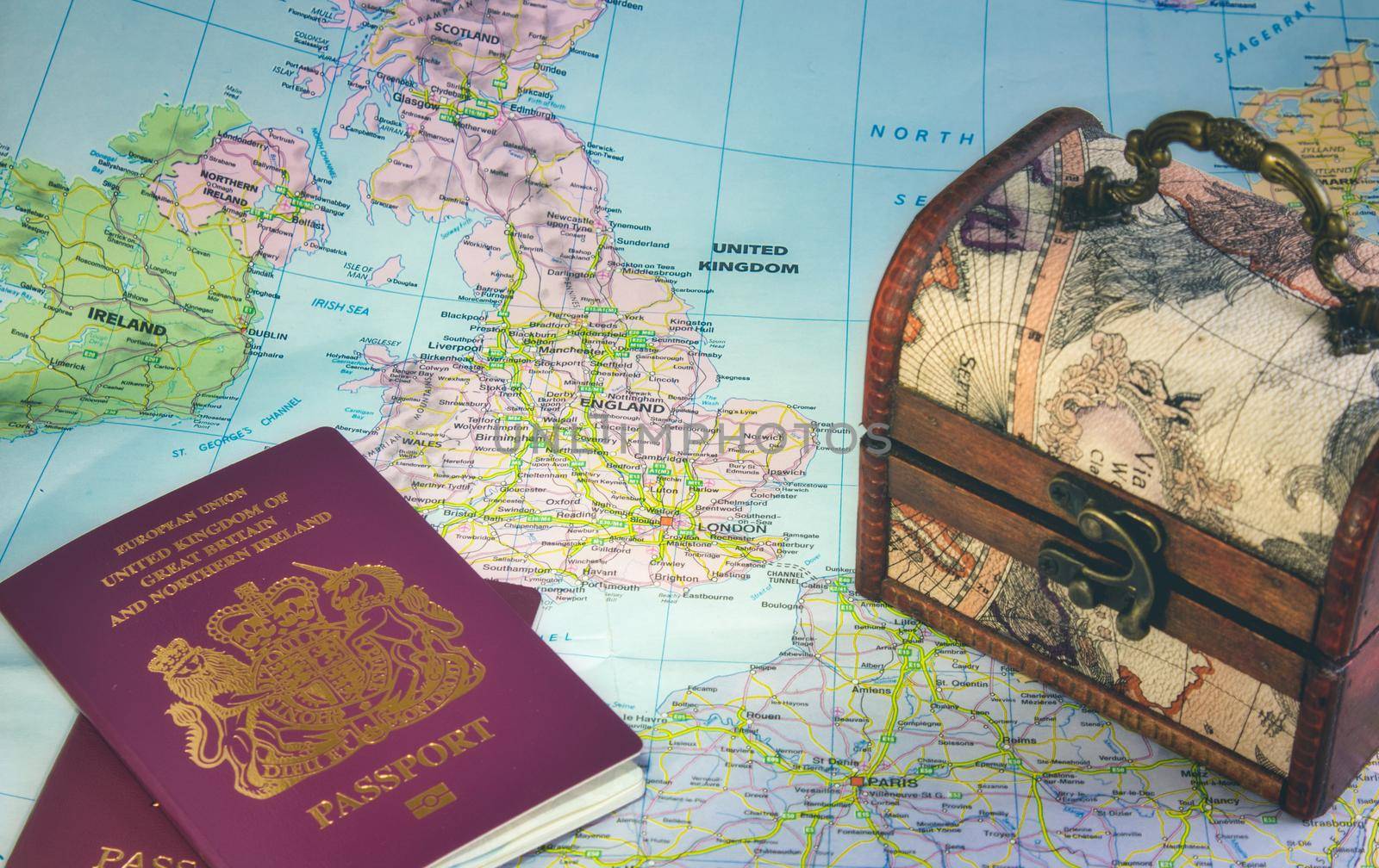 Map of Europe showing the UK, England, Ireland, France, British passports and a travel chest representing Brexit