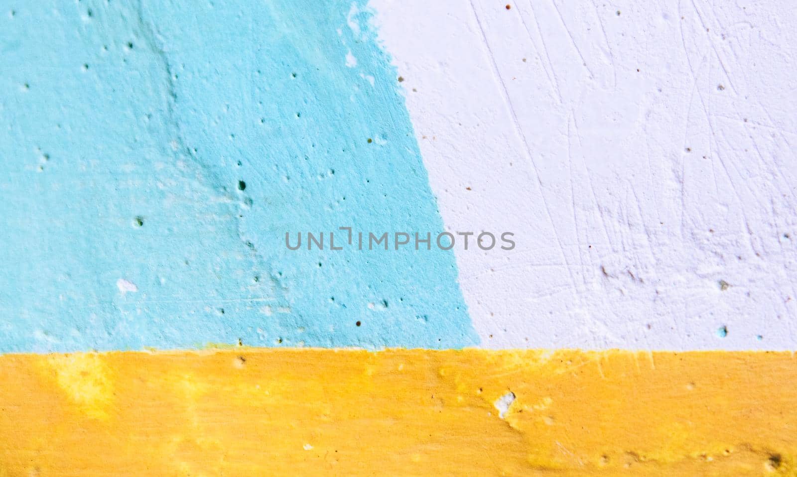 Painted cement wall with colored geometric pattern suitable for an abstract background texture
