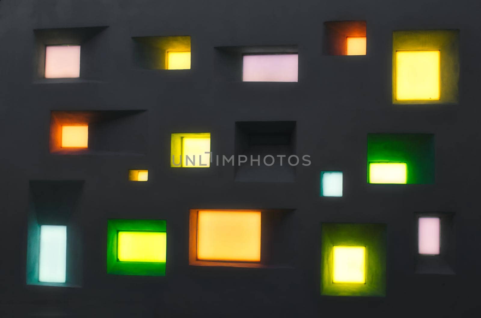Modern design wall with abstract windows of different shapes and colored lights
