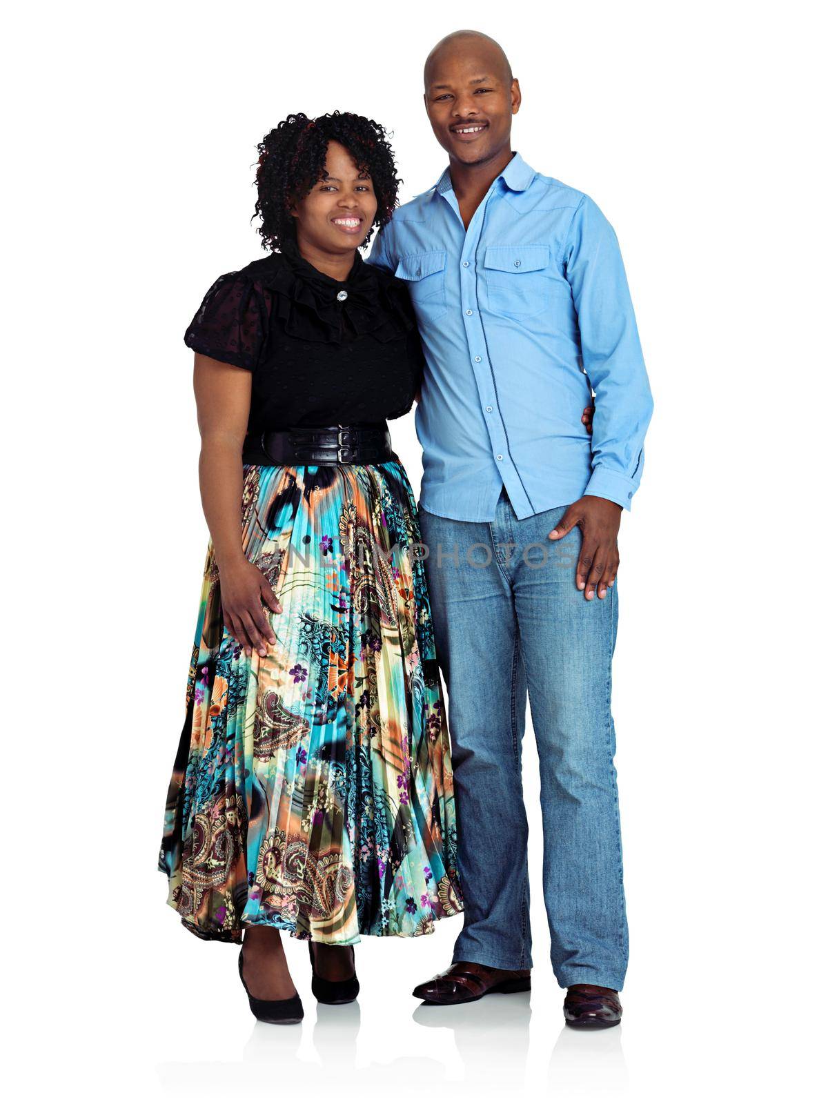 Studio shot of a happy black couple standing against a white background.