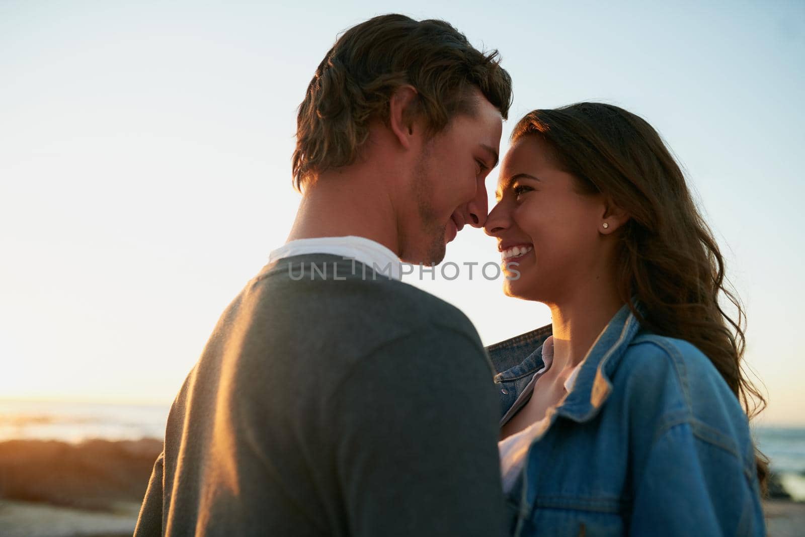 Shot of an affectionate young couple bonding at the beach.