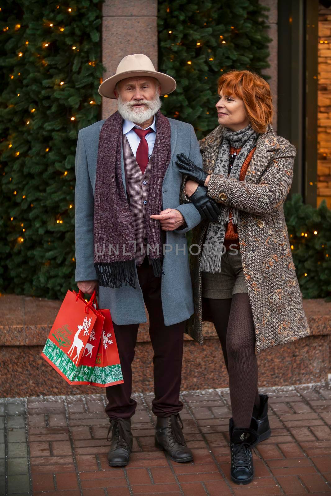 an elderly couple walking the streets of the city by zokov