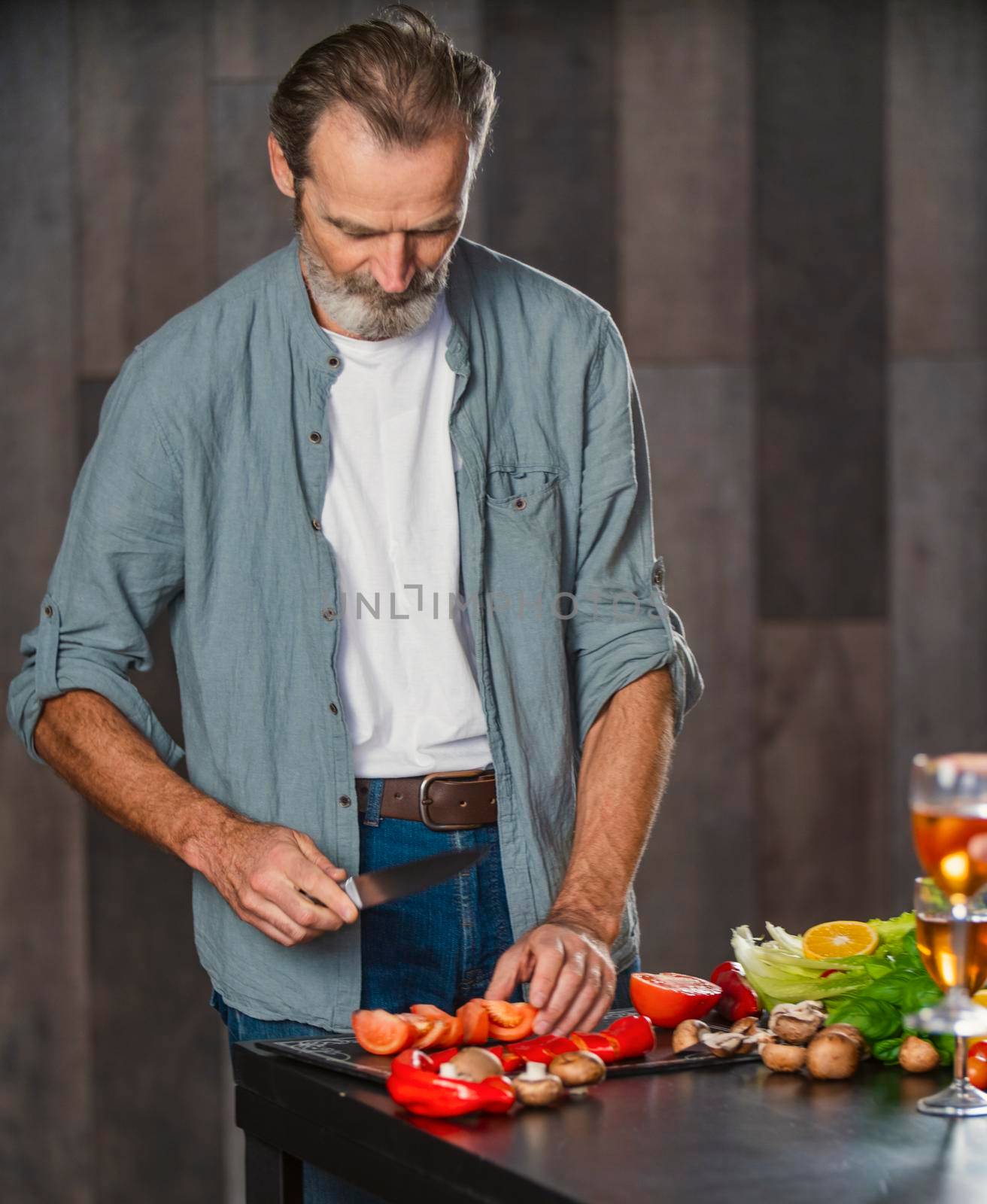 aged man cooking in the kitchen