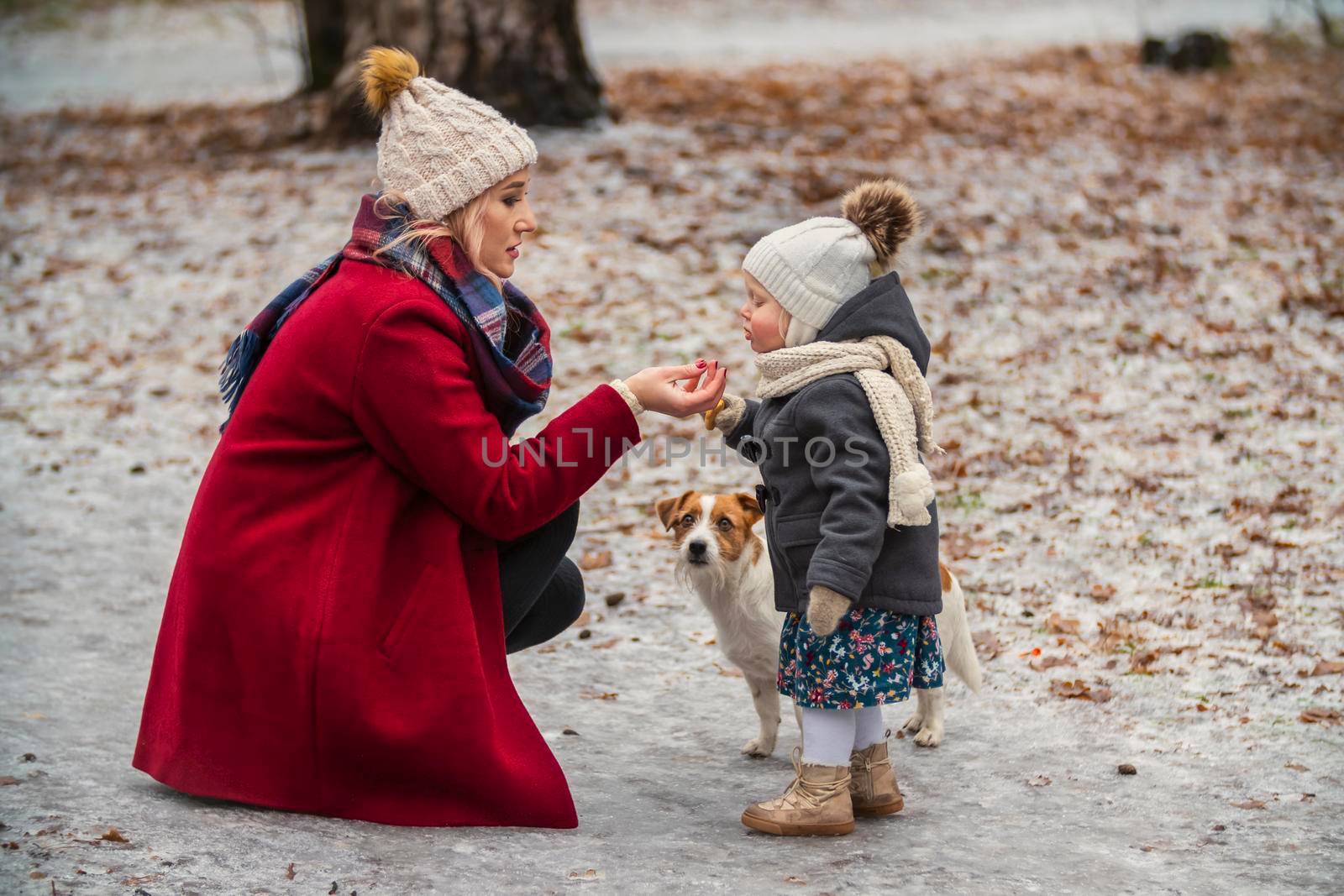 mom with daughter and dog in the park by zokov