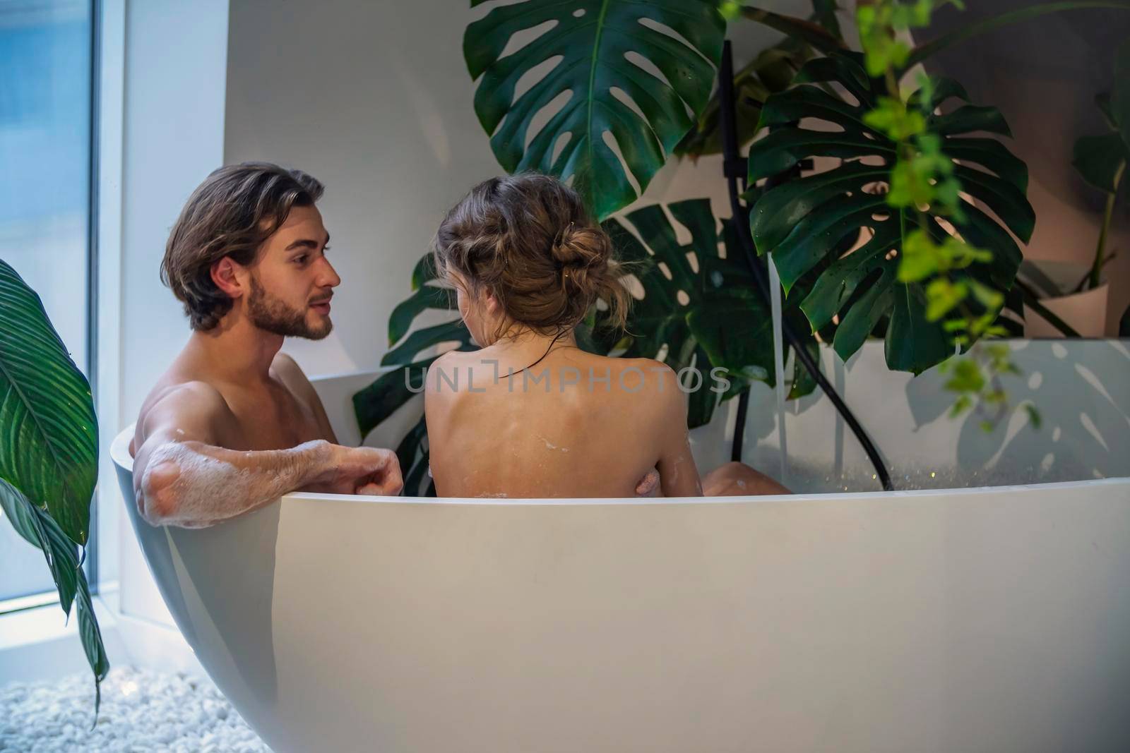 young couple bathes in the bath by zokov