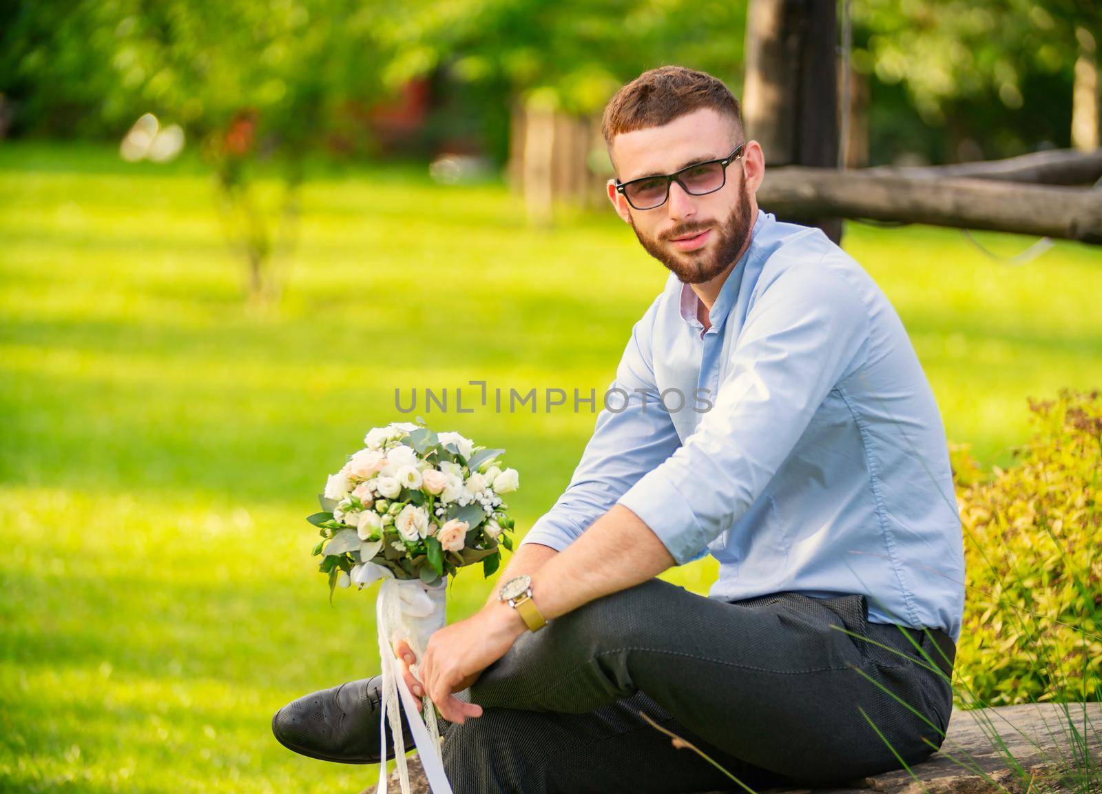 guy with a wedding bouquet in his hands