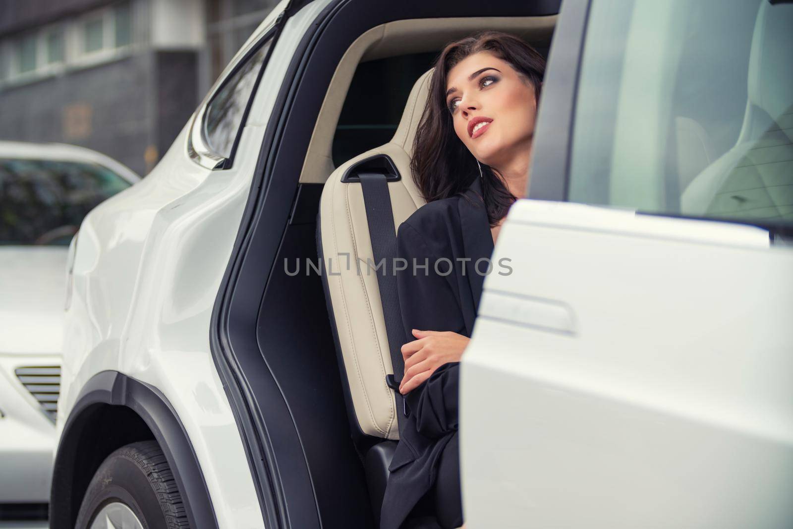girl sitting in the back seat of the car