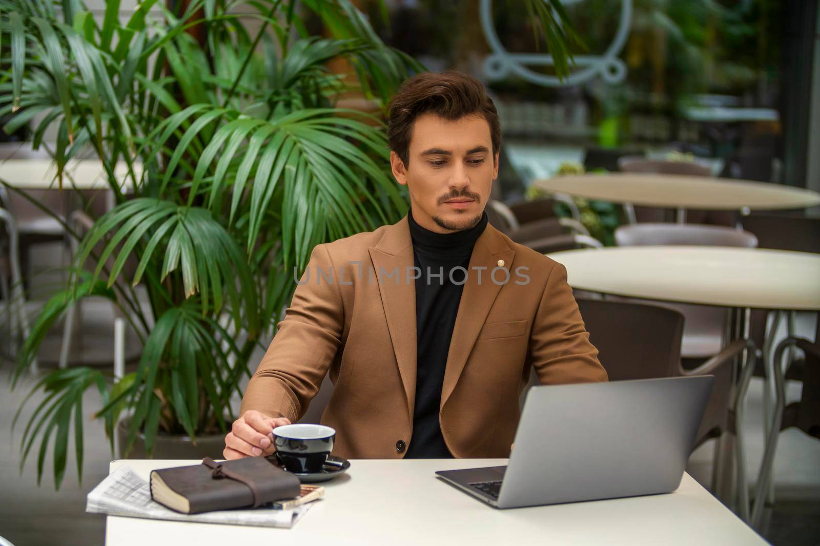 businessman sitting at the table and looking at the computer