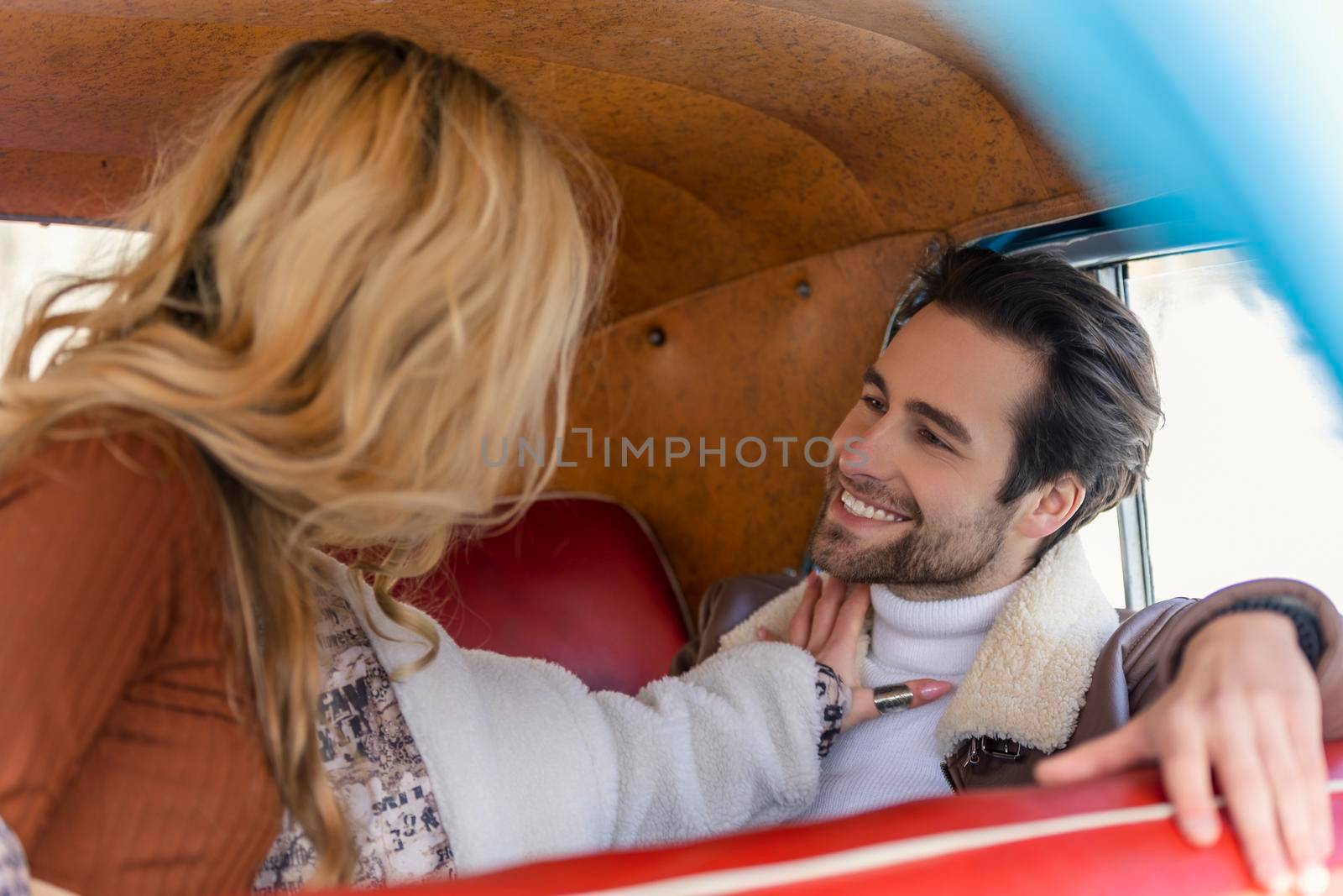 couple sitting in the back seat of a car by zokov