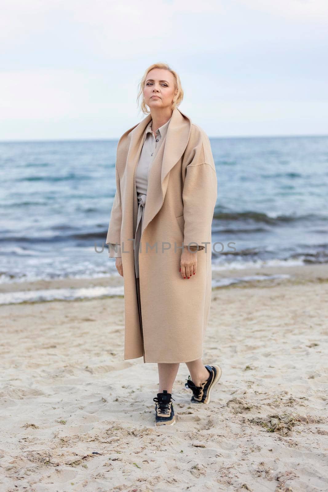 Woman in coat by the sea by zokov