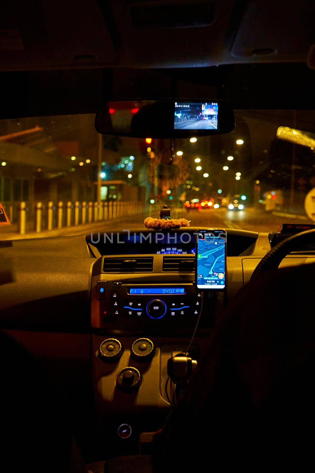 interior of a car driving night rainy city. blurred city lights. Kuala Lumpur, Malaysia - 03.12.2020