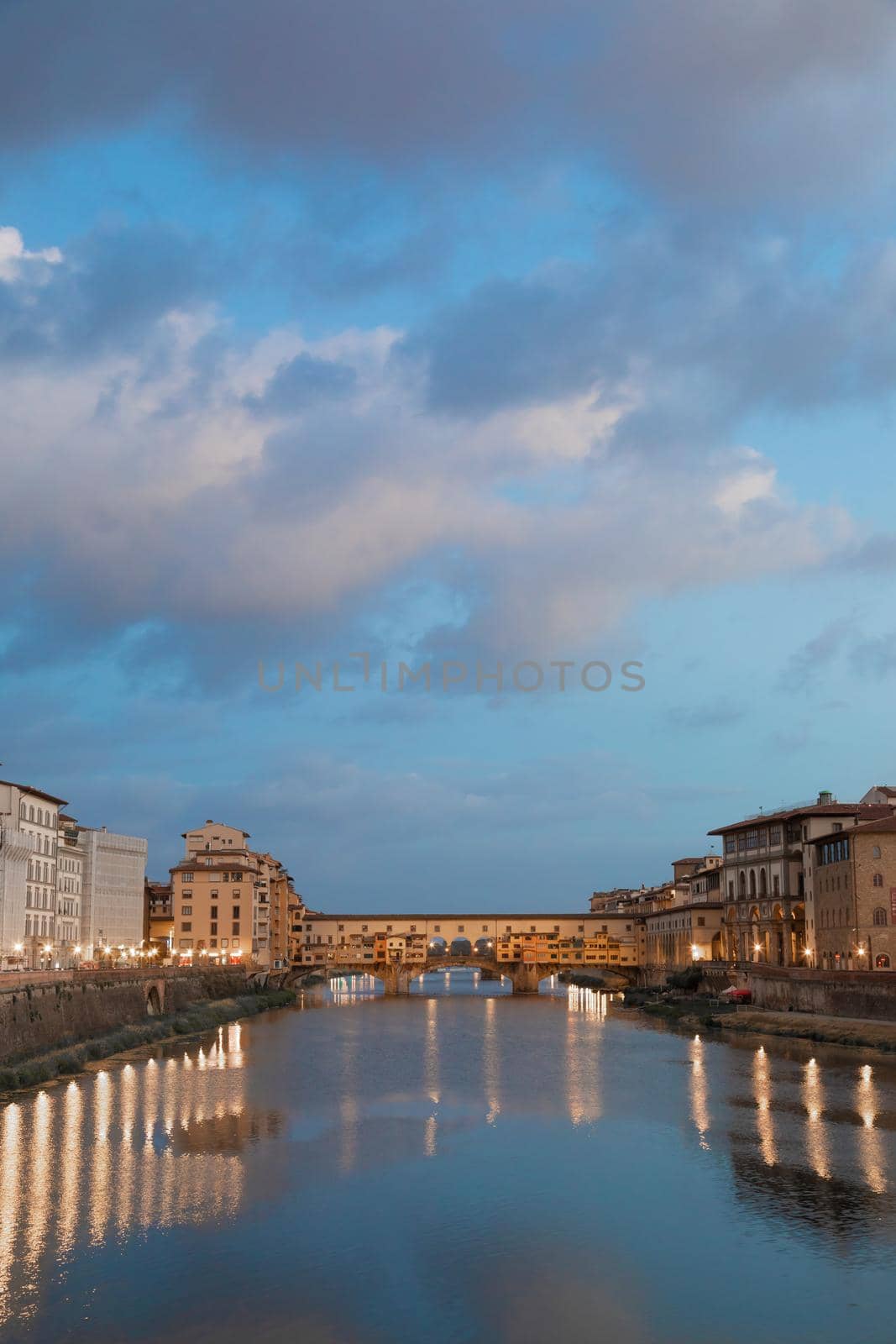 Florence, Italy - circa July 2021. Sunset light on Ponte Vecchio - Old Bridge.