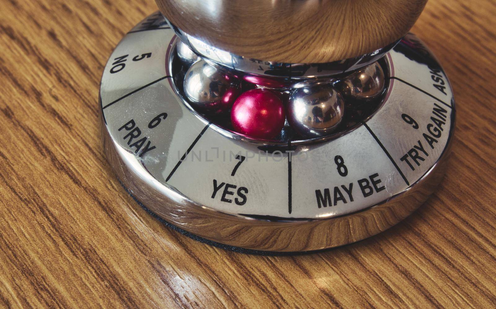 Metal decision maker with 'Yes' selected from the wheel of options