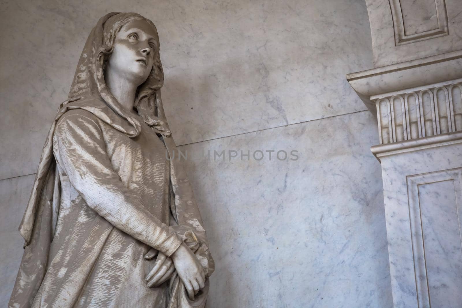 GENOA, ITALY - June 2020: antique statue, beginning 1800, made of marble, in a Christian Catholic cemetery - Italy