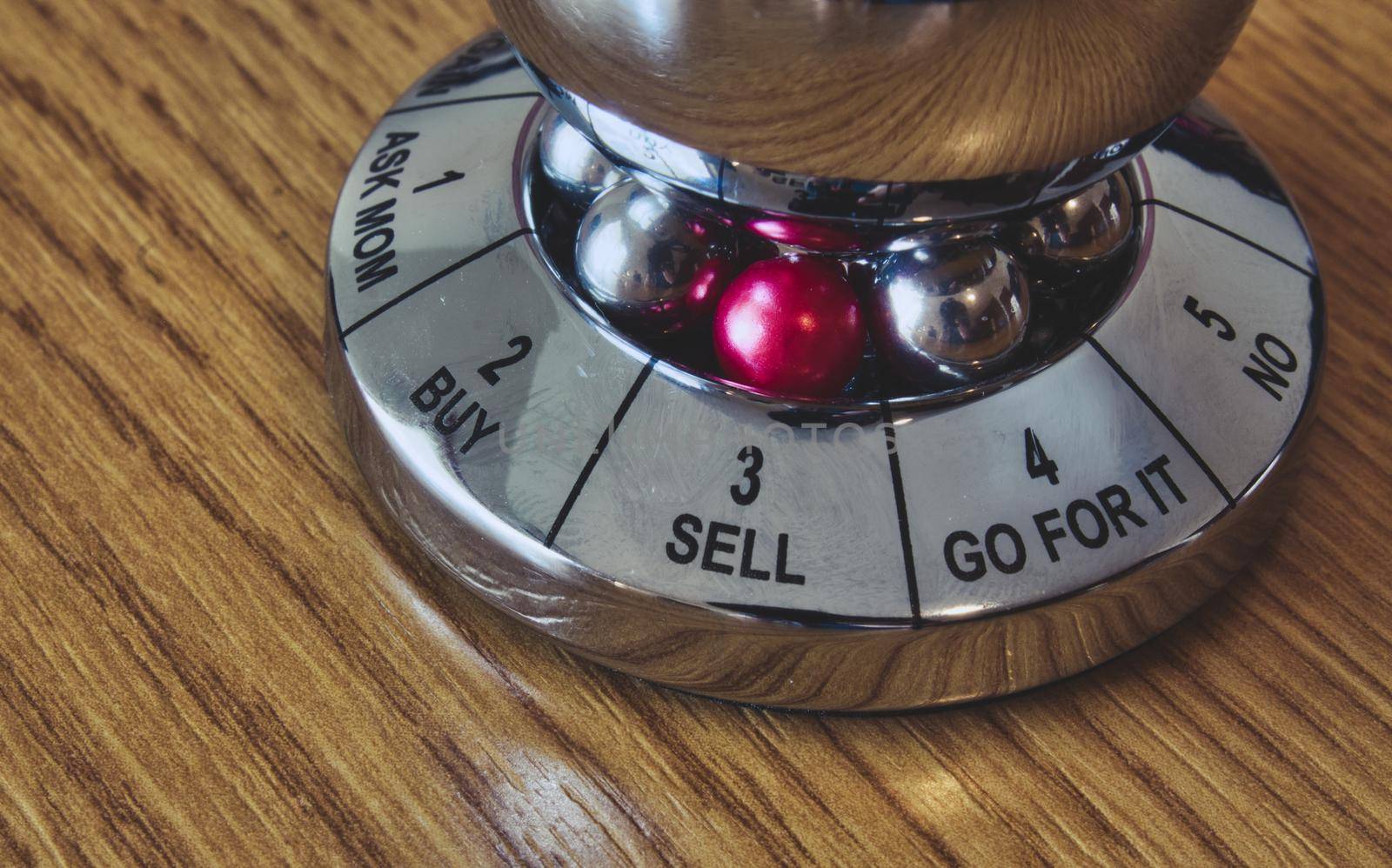 Metal decision maker with 'Sell' selected from the wheel of options