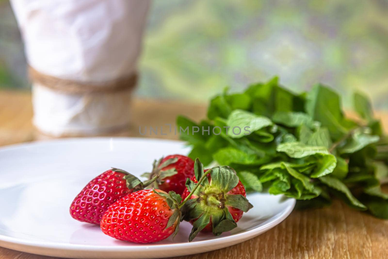 Fresh strawberries and mint - Ingredients for making healthy smoothie or summer drink cocktail. Closeup view.