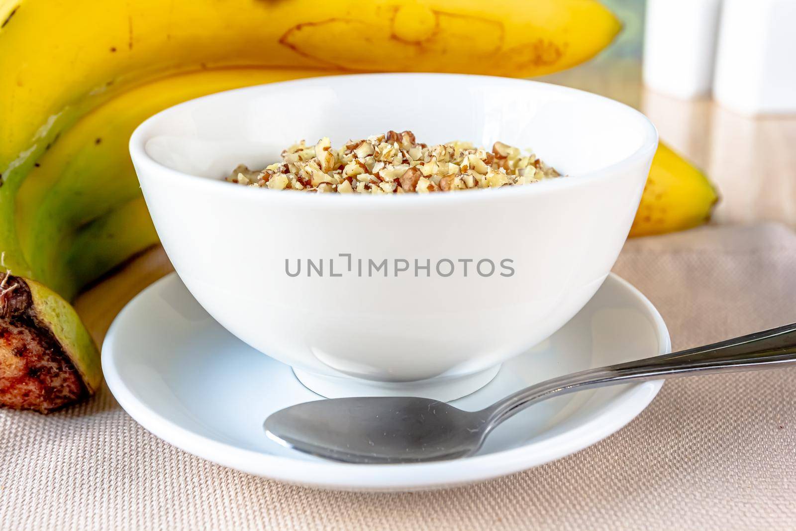 Dessert bowl of tasty chia seed pudding with banana on white background by Milanchikov