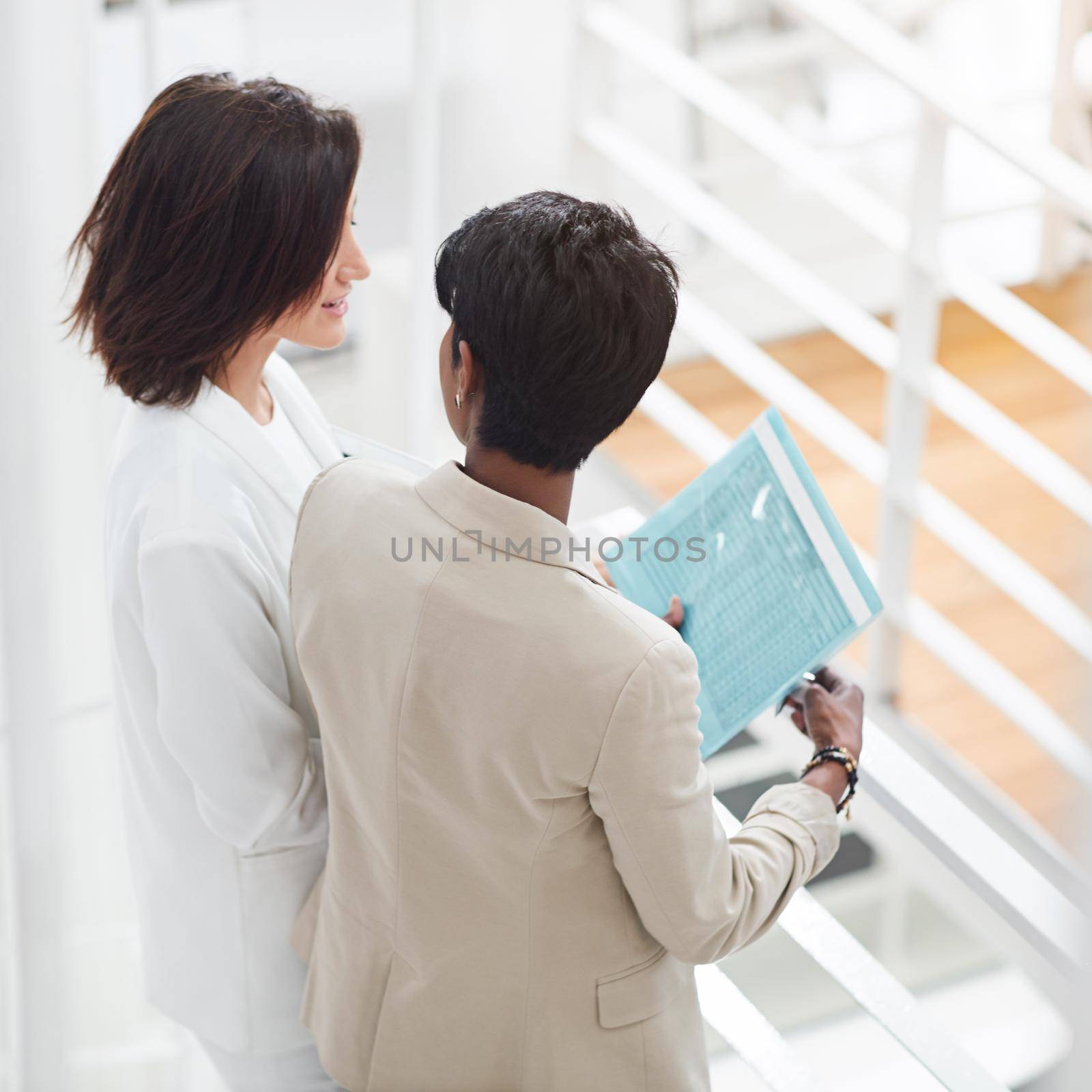 Shot of two businesswomen standing in an office.
