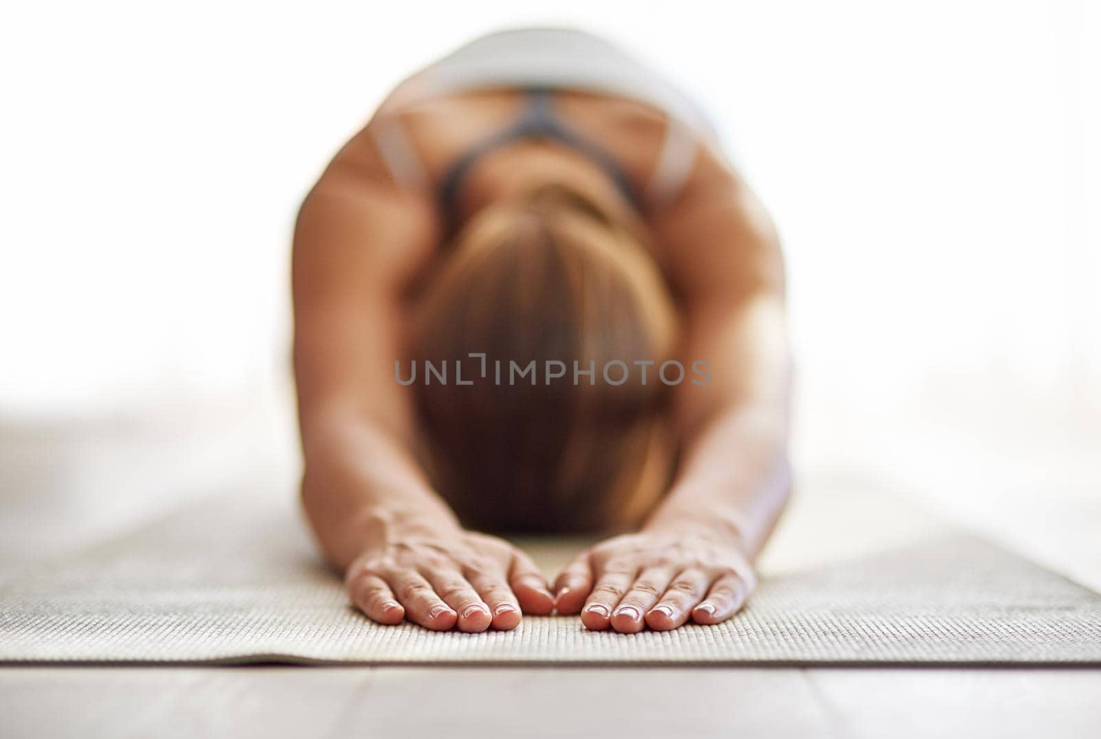 Get grounded and give gratitude. Shot of a young woman practicing yoga. by YuriArcurs