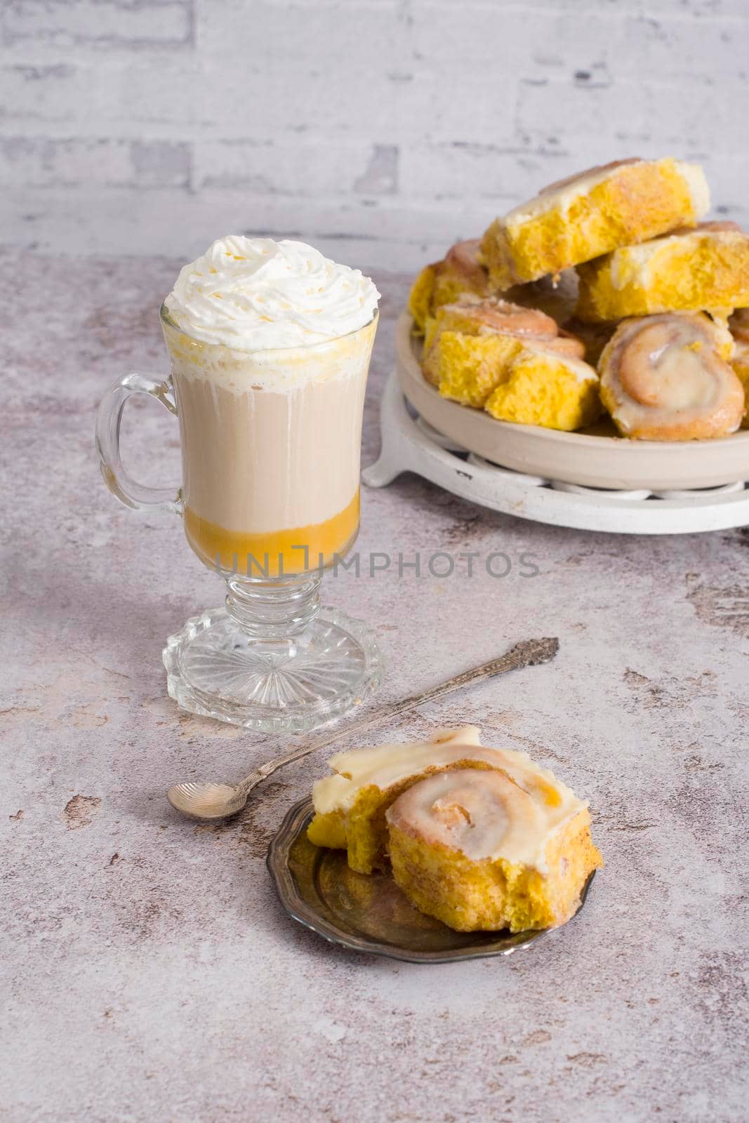 pumpkin cinnabons and latte for dessert, holiday table with pastries, home sweet by KaterinaDalemans