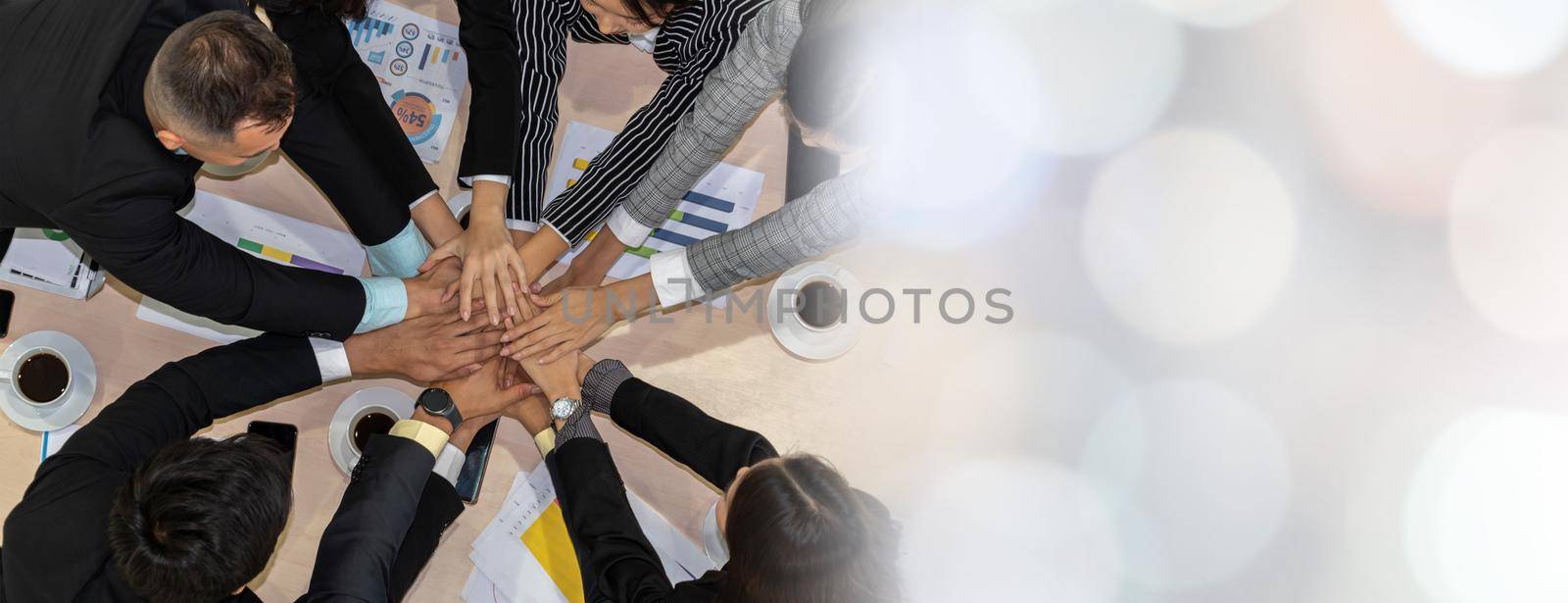 Happy business people celebrate teamwork success together with joy at office table shot from top view . Young businessman and businesswoman workers express cheerful victory in broaden view .