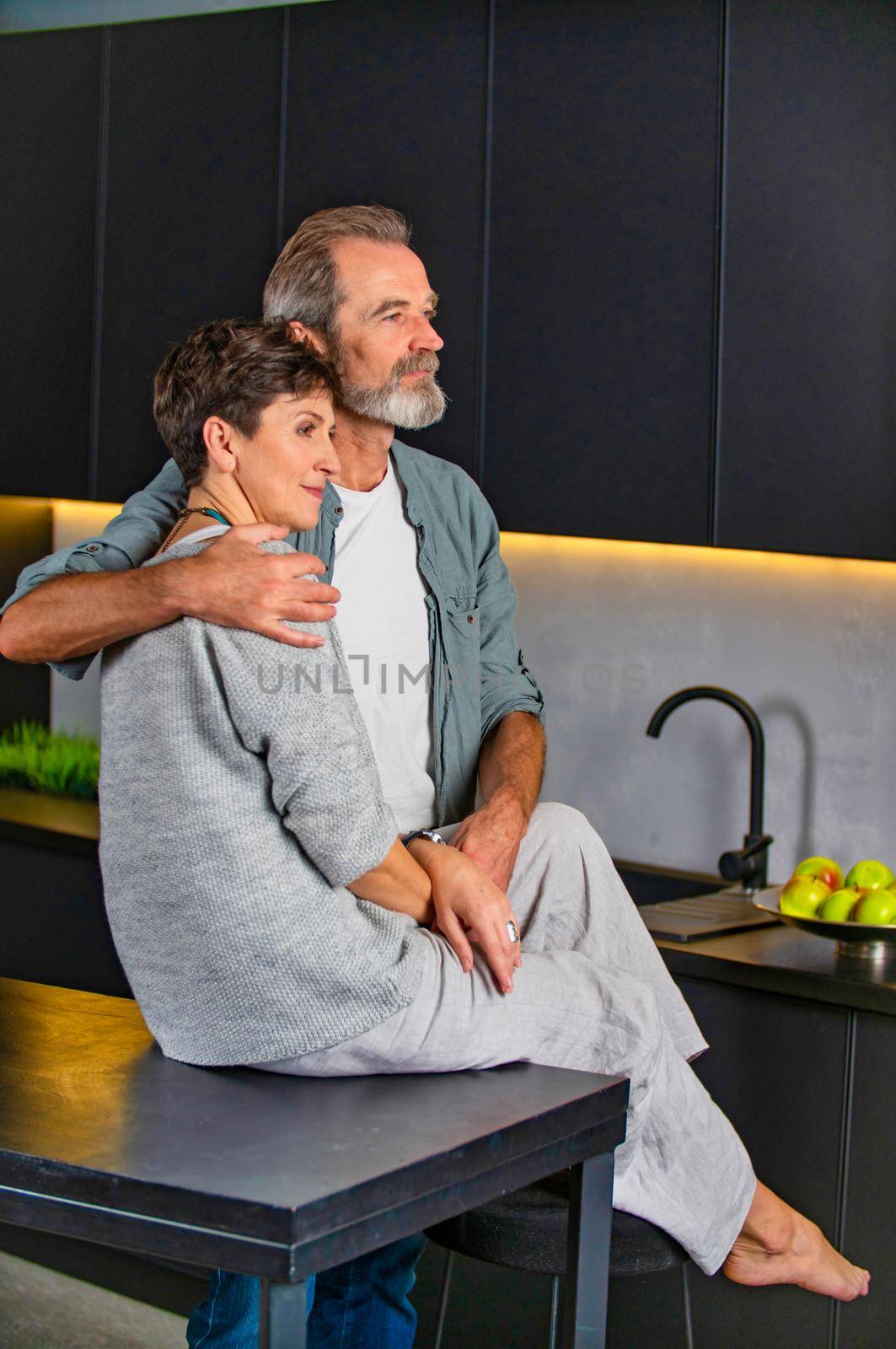 aged couple sitting in the kitchen