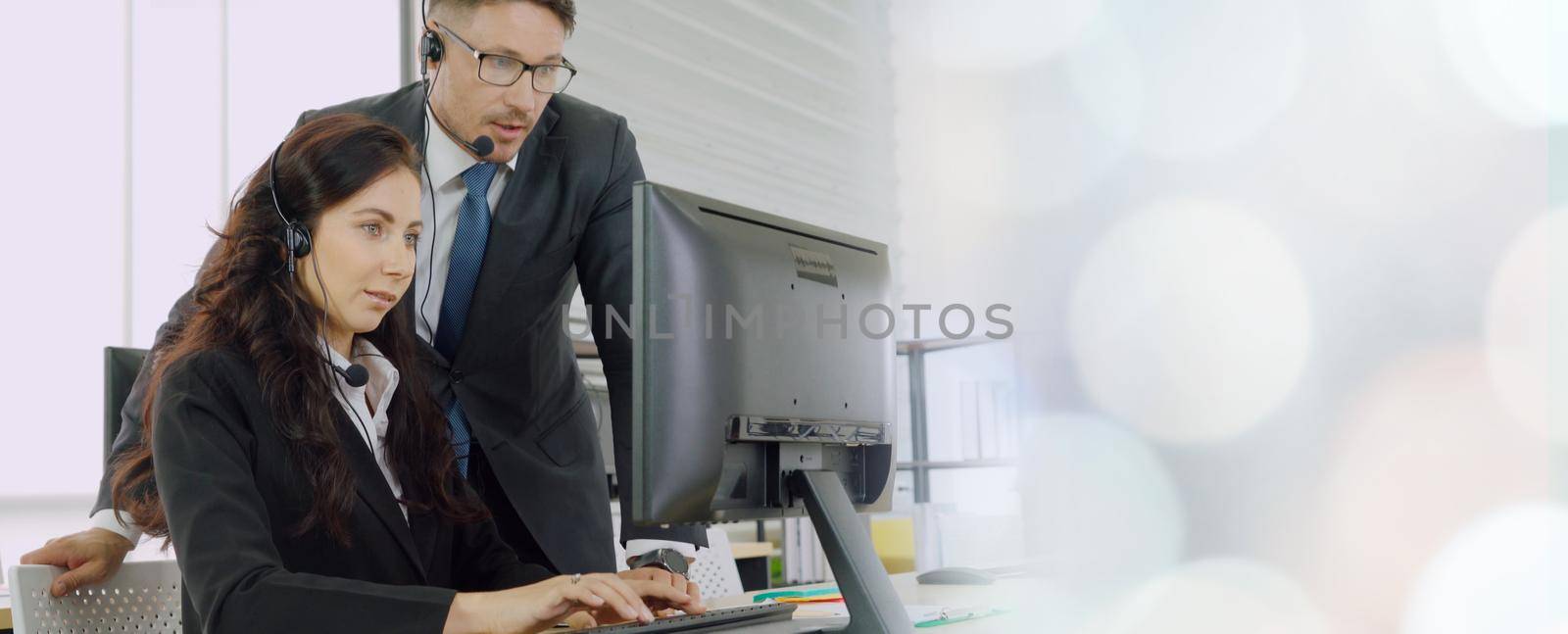 Business people wearing headset working in office broaden view by biancoblue