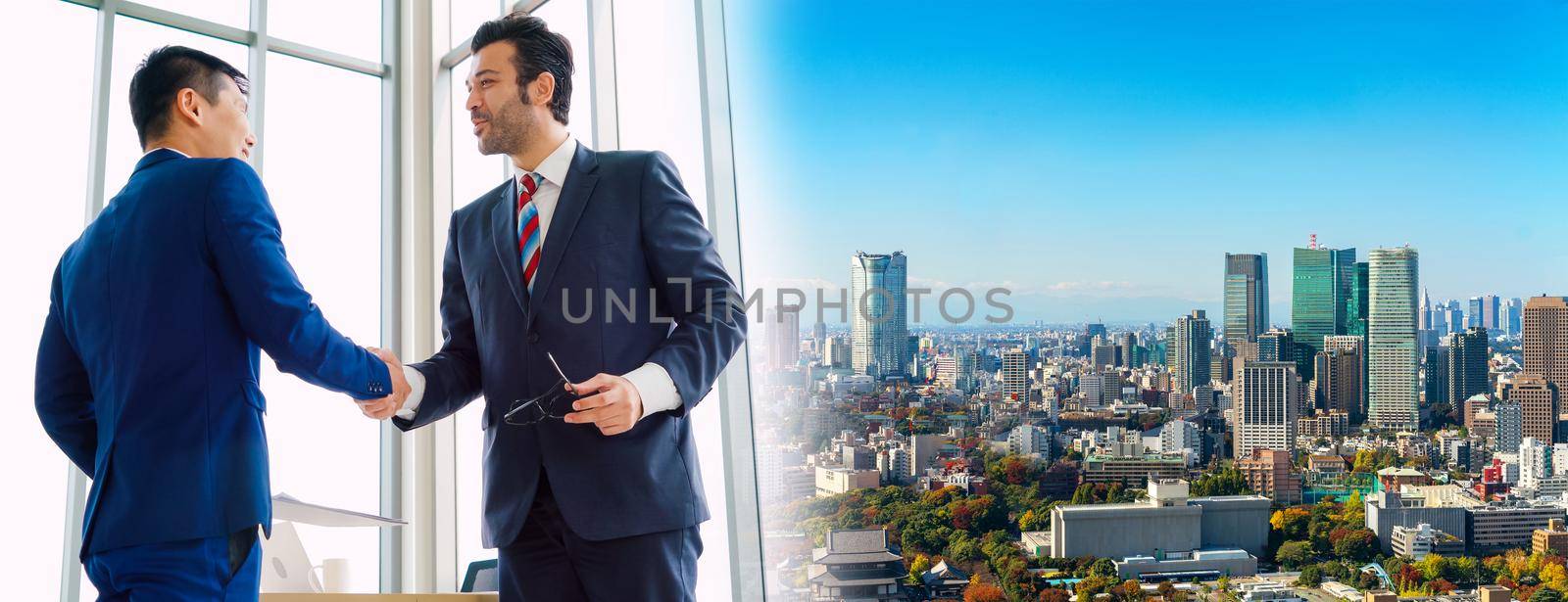 Business people handshake in corporate office in widen view showing professional agreement on a financial deal contract.