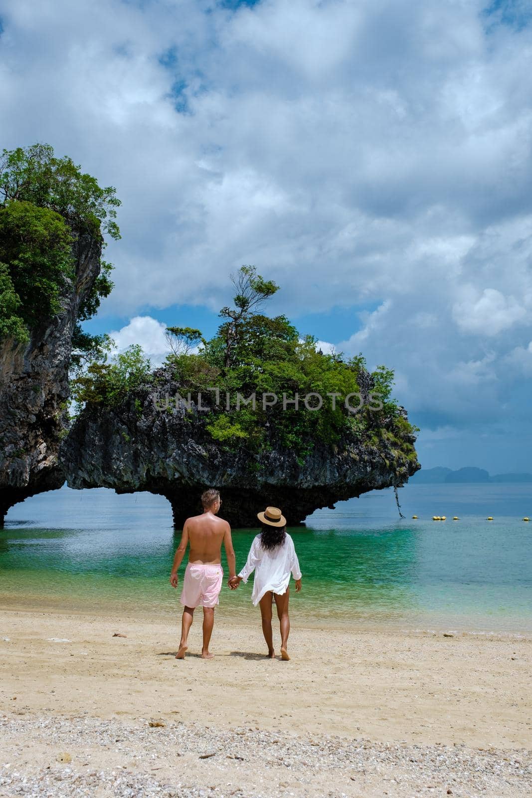 Koh Phakbia Island near Koh Hong Krabi, beautiful white sandy beach of Krabi Thailand. Young Asian woman and European men on the beach by fokkebok