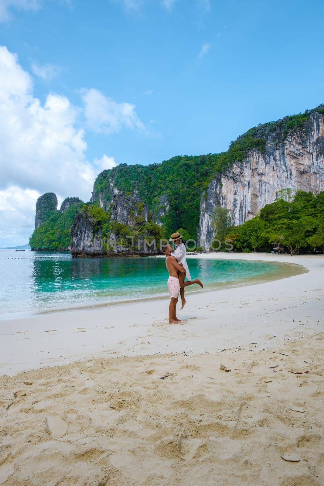 Koh Hong Island Krabi Thailand, couple of men and woman on the beach of Koh Hong, tropical white beach with Asian woman and European men by fokkebok