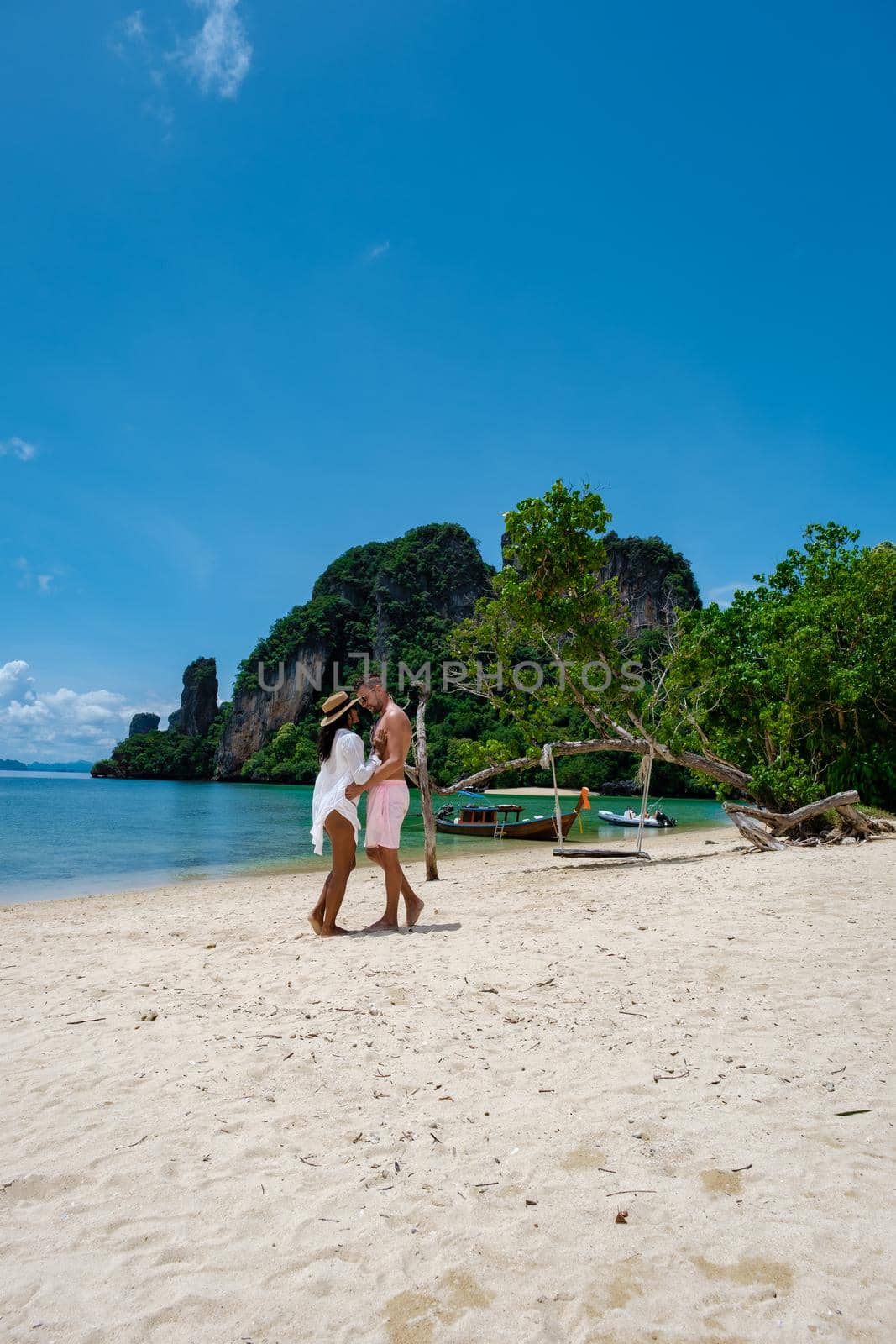 Koh Phakbia Island near Koh Hong Krabi, beautiful white sandy beach of Krabi Thailand. Young Asian woman and European men on the beach by fokkebok