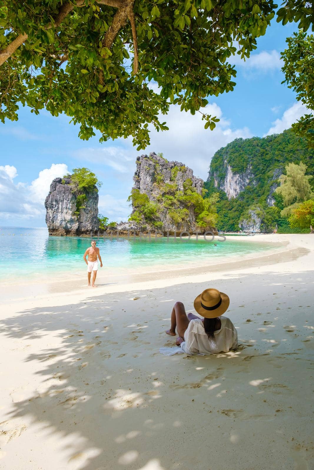 Koh Hong Island Krabi Thailand, a couple of men and women on the beach of Koh Hong, a tropical white beach with Asian women and European men in Krabi Thailand