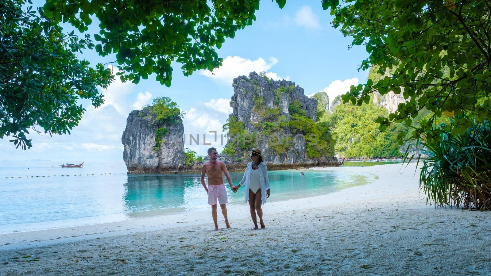 Koh Hong Island Krabi Thailand, couple of men and woman on the beach of Koh Hong, tropical white beach with Asian woman and European men by fokkebok