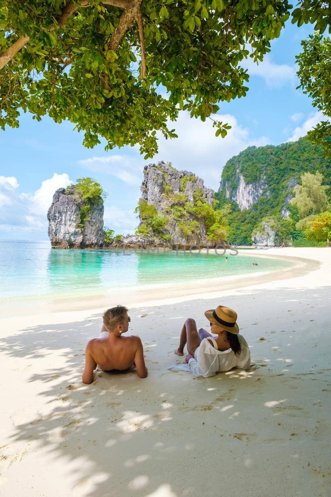 Koh Hong Island Krabi Thailand, couple of men and woman on the beach of Koh Hong, tropical white beach with Asian woman and European men by fokkebok