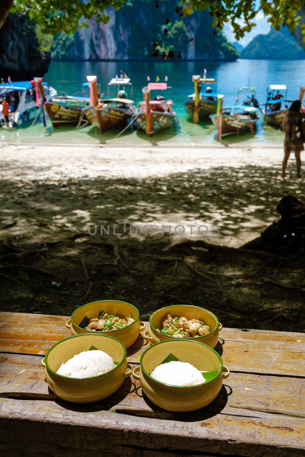 Koh Lao Lading near Koh Hong Krabi Thailand, beautiful beach with longtail boats, couple European men and Asian woman on the beach by fokkebok