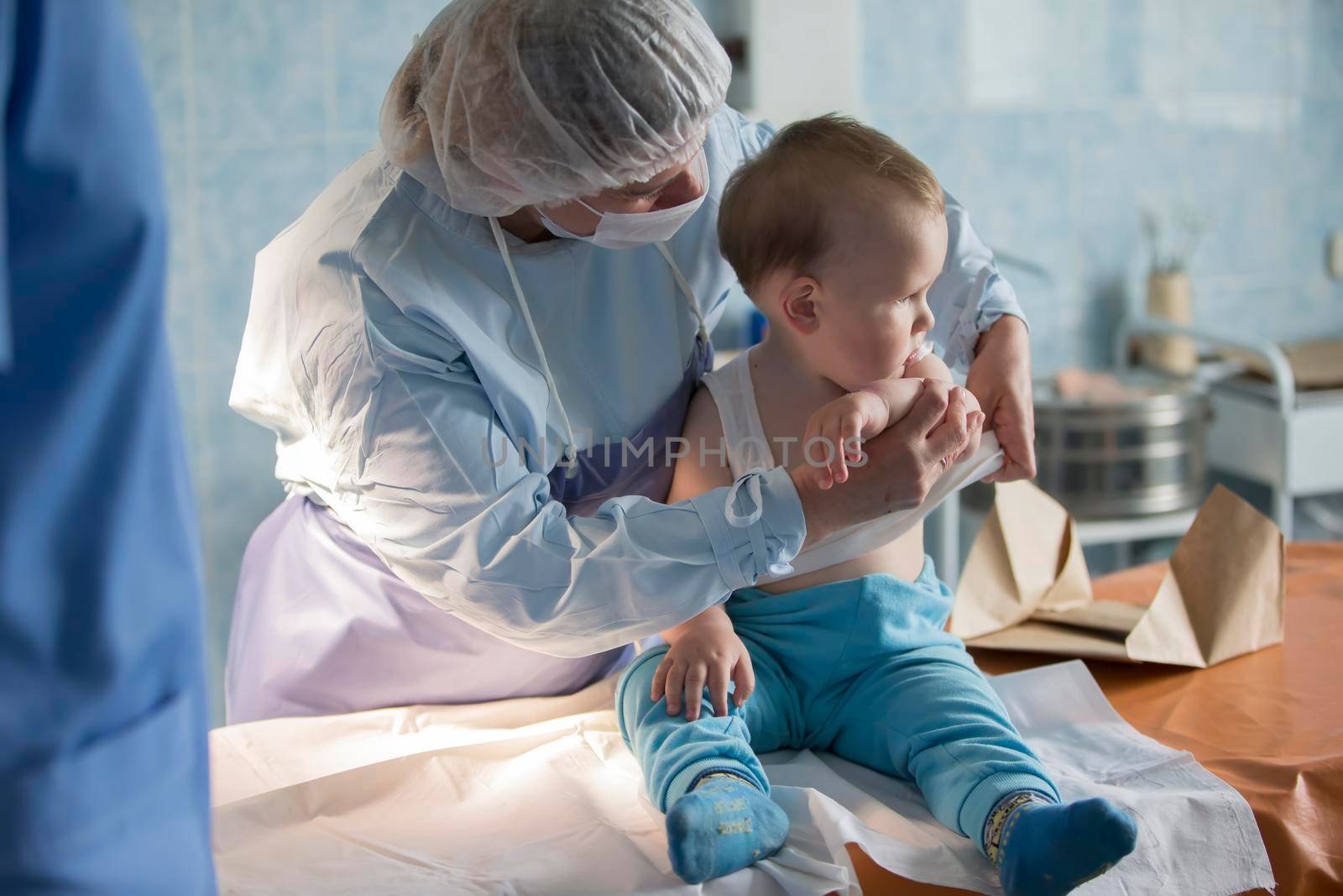 A little boy nurse treats a burn. A child in the hospital is injured. The doctor treats the baby. Little hospital patient.