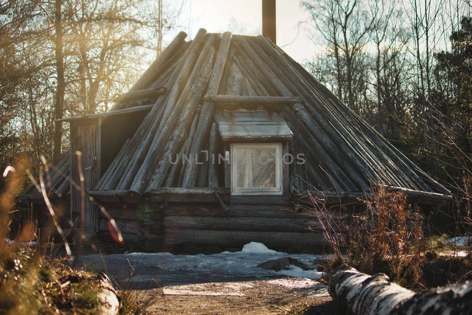 A traditional wooden log cabin on in the forest