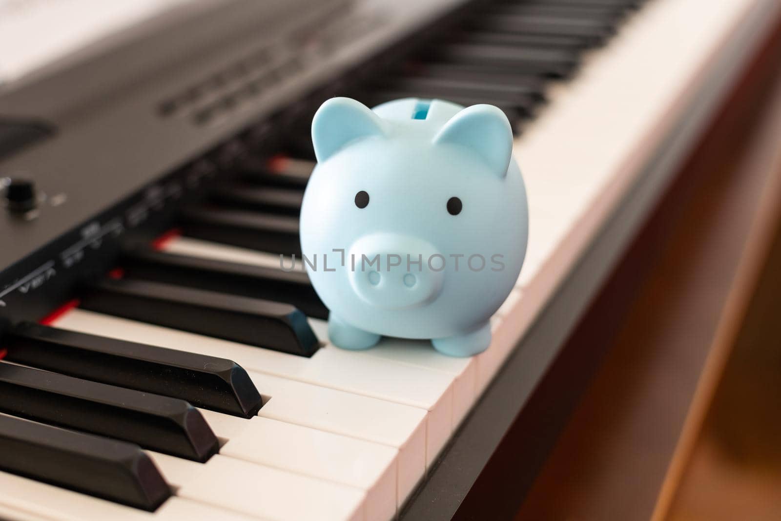 music and saving concept with piano and piggy bank by Andelov13