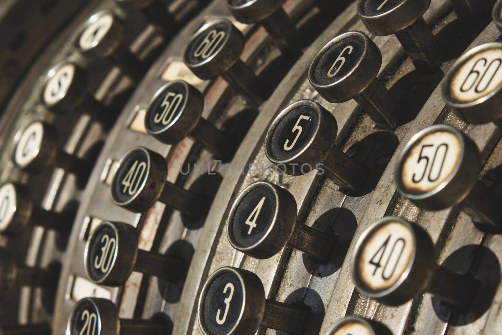 Close-up of numbered buttons on antique cash register