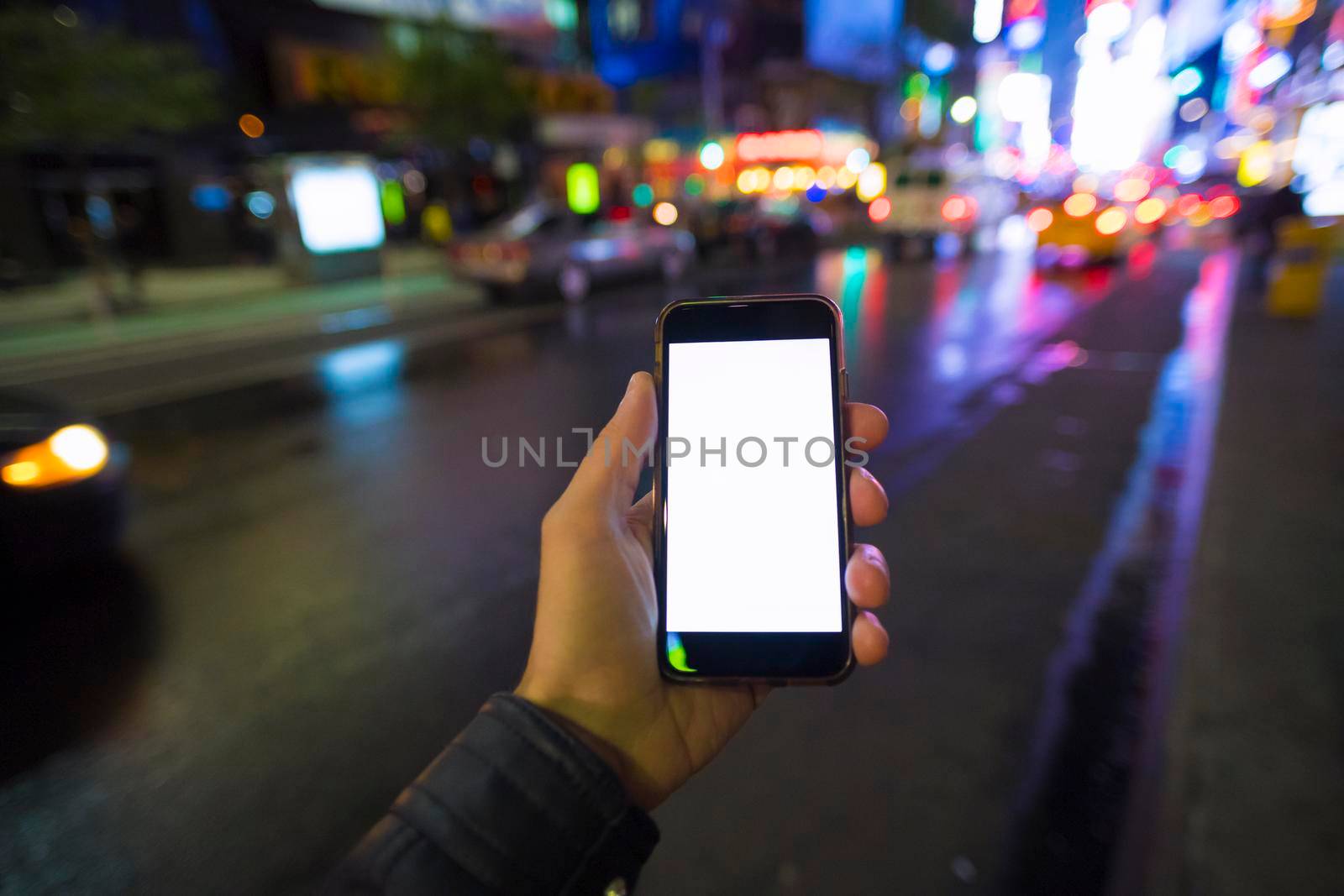 man holding a mobile phone in Manhattan New York City by SimmiSimons