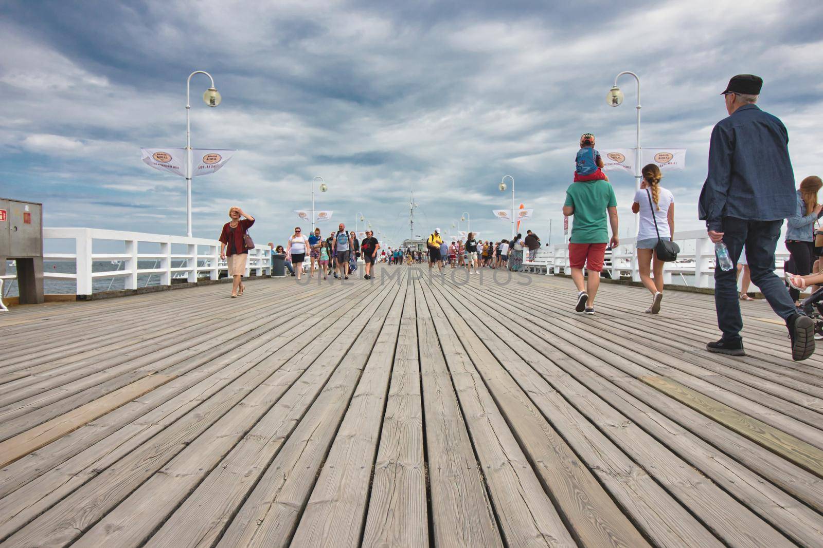 Sopot / Croatia - August 3 2019: People walking on the wooden boards of the pier at Sopot beach