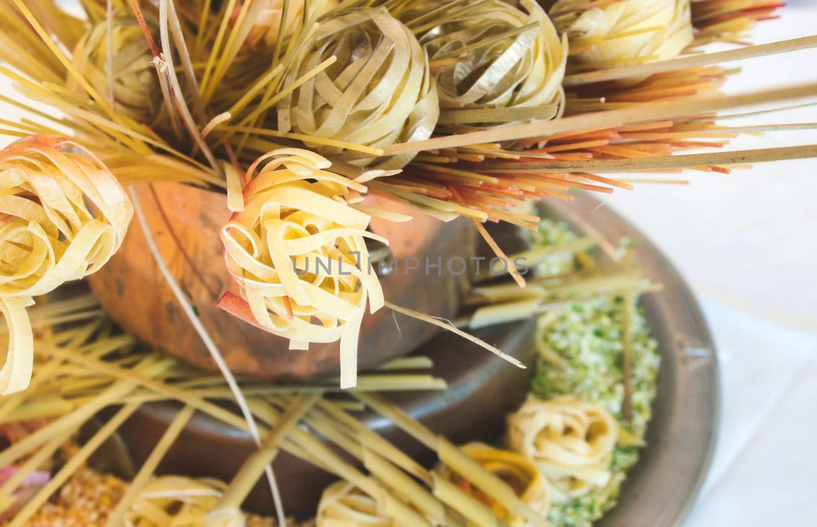Arrangement of various types of pasta on display against a white background