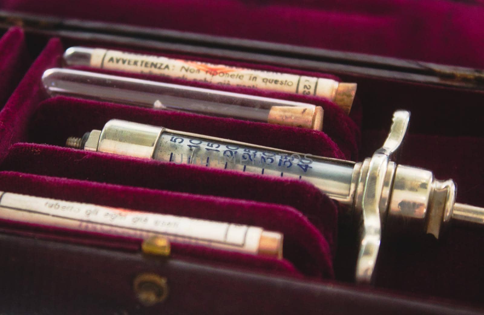 Old-fashioned syringe in a red case