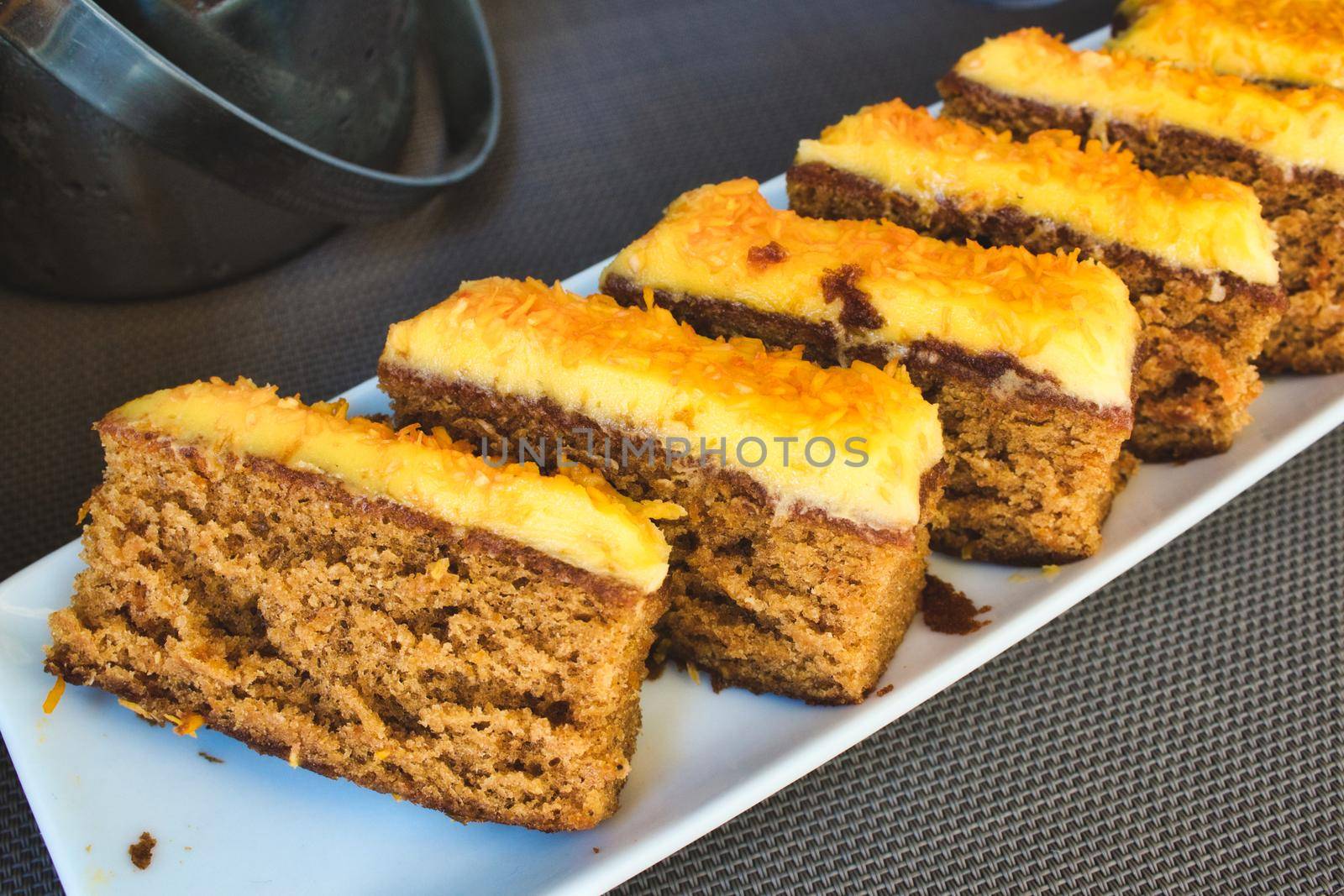 Slices of carrot cake with orange peel frosting by tennesseewitney