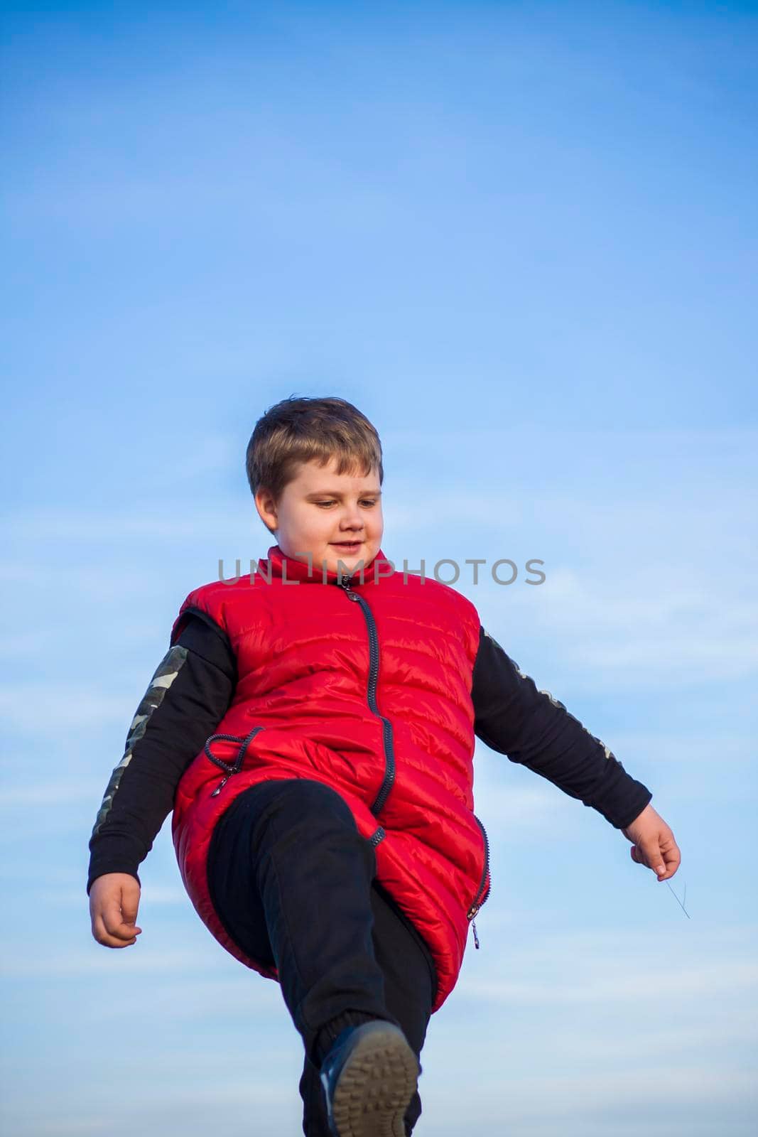 A child stands on top of a cliff and watches what is happening below. panoramic view from the top of a rocky mountain. Russia, Rostov region, skelevataya skala, the 7th wonder of the Don world. Landscape