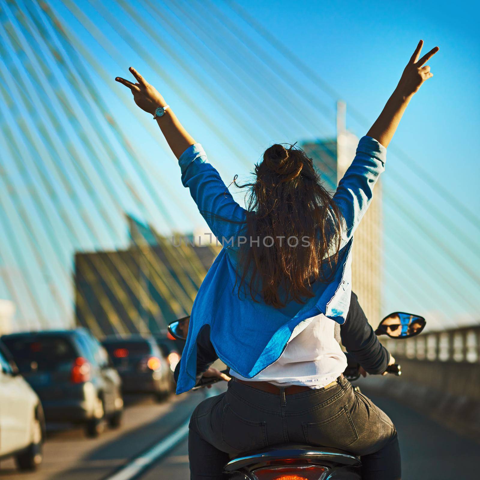 Find your zen along the road. Cropped shot of a young attractive couple riding a scooter around town. by YuriArcurs