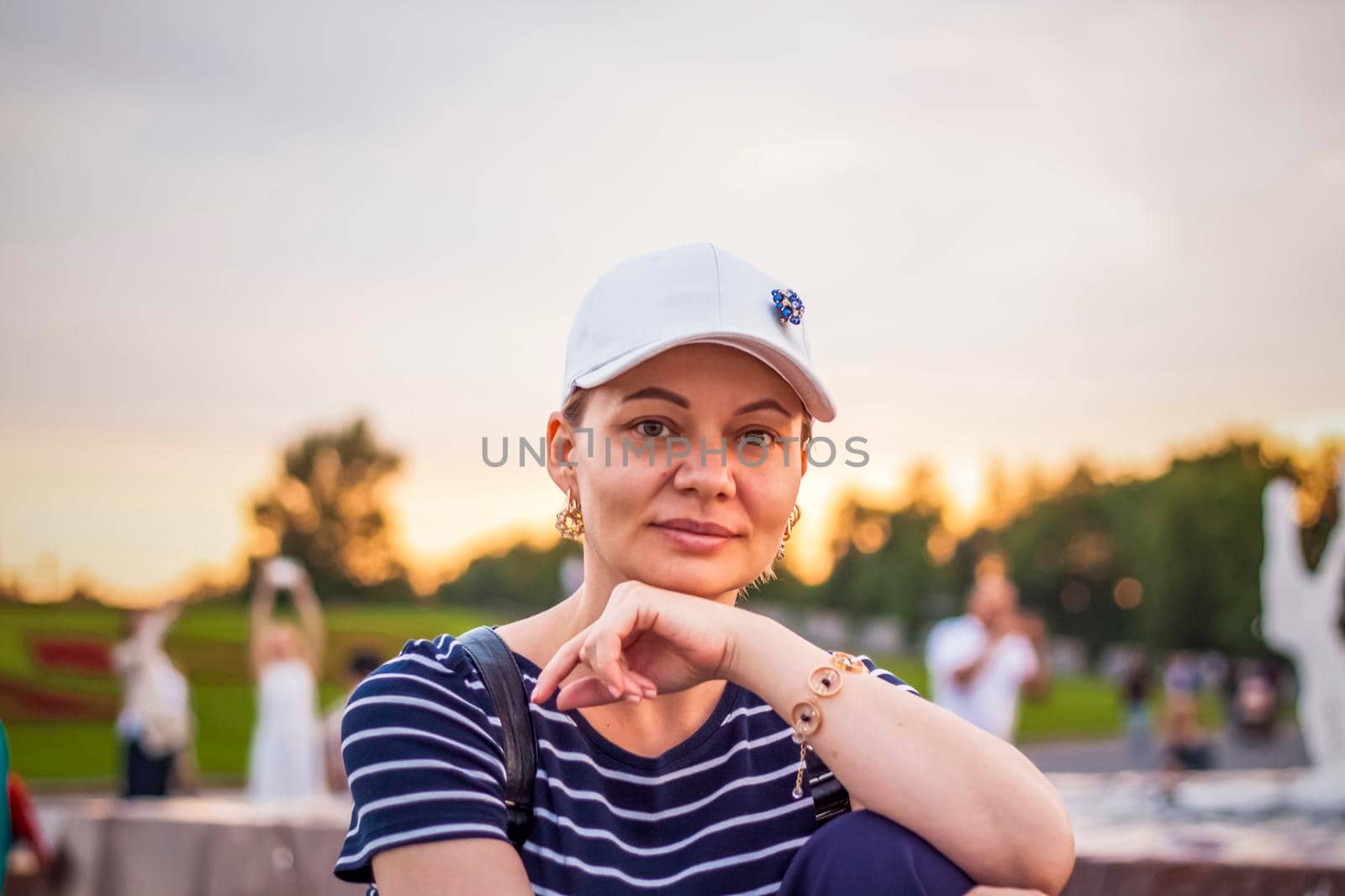 Portrait of a girl in a cap on the background of an open-air urban landscape. Travel. Lifestyle in the city. Center, streets. Summer, a walk.