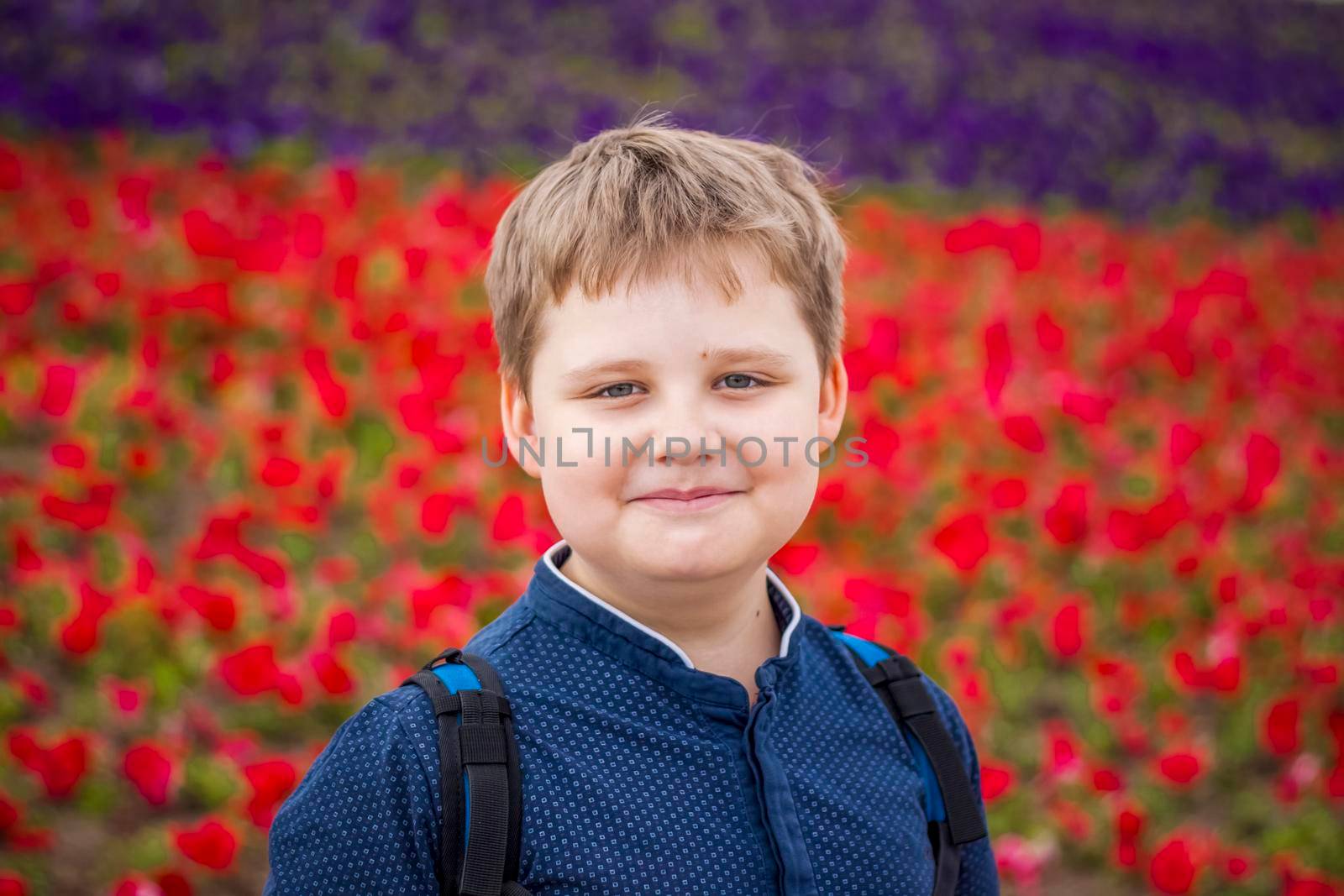 Portrait of a child, a boy against the backdrop of urban landscapes of skyscrapers and high-rise buildings in the open air. Children, Travel. Lifestyle in the city. Center, streets. Summer, a walk.